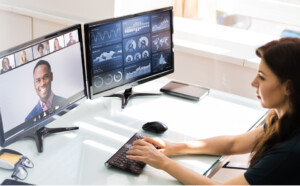 Woman working on 3 screens Zoom call