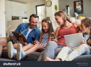 Streaming happy family sitting on sofa. Fast Internet.